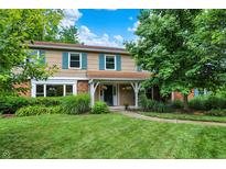 Charming two-story home with a well-manicured lawn and beautiful landscaping at 9036 Buckeye Ct, Indianapolis, IN 46260