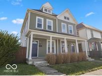 Charming two-story home featuring a welcoming front porch and classic architectural details at 921 S State Ave, Indianapolis, IN 46203