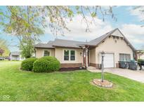 Charming single-story home featuring a manicured lawn and attached garage, perfect for suburban living at 980 Red Maple Ct, Greenwood, IN 46143