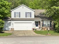 Charming two-story home with a two car garage, brick accents, and well-manicured lawn at 1334 Legacy Ct, Indianapolis, IN 46234