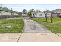 Charming single-story home with a well-maintained lawn and long driveway entrance at 1391 N Shadeland Ave, Indianapolis, IN 46219