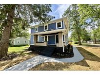 Charming blue two-story home with a welcoming front porch and landscaped yard at 1601 E Edwards Ave, Indianapolis, IN 46227