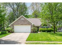 Charming single-story brick home featuring an attached two-car garage and a well-manicured front lawn at 19519 Creekview Dr, Noblesville, IN 46062