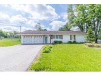 Charming single-story home featuring a two car garage and a well manicured lawn at 2237 W 100 N, Greenfield, IN 46140