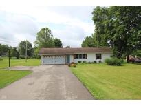 Charming ranch home with attached two-car garage and well-manicured lawn at 2237 W 100 N, Greenfield, IN 46140