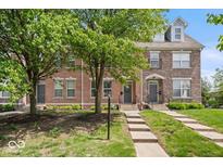 Brick townhome featuring meticulous landscaping, sidewalks and inviting front entrances at 2405 N Park Ave, Indianapolis, IN 46205
