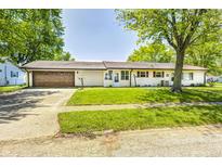 Charming single-story home featuring a well-maintained lawn and a two-car attached garage at 423 W Janet Dr, Brownsburg, IN 46112