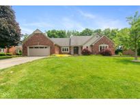 Charming brick home with a well-manicured lawn, attached garage, and beautiful landscaping at 4351 W Fox Ridge Ave, Greenwood, IN 46143