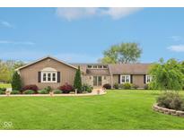 Charming ranch home featuring professional landscaping, covered entry, stone accents and a sprawling front lawn at 4732 Ferguson Rd, Indianapolis, IN 46239