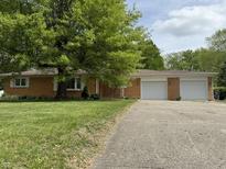 Charming brick ranch home with a two car garage and mature trees at 6335 Linden Dr, Indianapolis, IN 46227