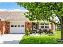 Charming single-story home with a well-manicured lawn, and quaint front porch seating at 8145 Bentley Farms Dr, Indianapolis, IN 46259