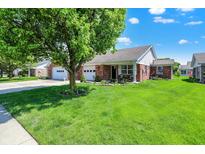 Charming single-story brick home with a well-maintained lawn and inviting curb appeal at 8145 Bentley Farms Dr, Indianapolis, IN 46259