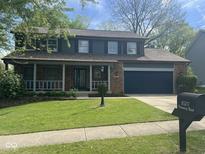 Charming two-story home with a well-manicured lawn and attached two car garage at 8507 Promontory Rd, Indianapolis, IN 46236