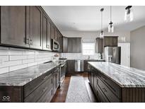 Modern kitchen featuring sleek countertops, stainless steel appliances, and ample cabinetry for storage at 863 N Park Trail Dr, Carmel, IN 46032