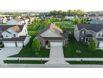 Beautiful aerial view of home showing manicured lawn and community park with walking trails and playground at 934 Steel Horse Dr, Westfield, IN 46074