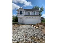 Two-story home featuring a large garage and covered in Barricade Building Wrap at 1041 Fuller Ln, Shelbyville, IN 46176
