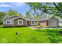 Charming single-story brick home with a well-manicured lawn and landscaping at 10444 Collingswood Ln, Fishers, IN 46037