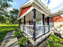 Inviting covered front porch with stylish railing and well-maintained landscaping at 10751 N Kitchen Rd, Mooresville, IN 46158