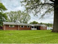 Charming brick ranch home with a large front yard and mature trees at 10946 Maze Rd, Indianapolis, IN 46259