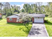 Charming brick ranch home with well-maintained lawn and attached two-car garage at 11603 Peacock Dr, Indianapolis, IN 46236
