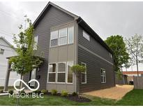 Modern two-story home with gray siding and multiple windows allowing for lots of natural light at 1215 Herbert St, Indianapolis, IN 46202