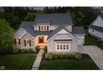 Front exterior of well-maintained property showcasing architectural details, landscaping, and a welcoming entrance at 14003 Grannan Ln, Carmel, IN 46074