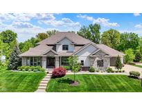 Charming two-story home with stone accents, lush lawn, and well-maintained landscaping at 16731 George Gang Blvd, Westfield, IN 46062