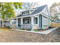 Charming home featuring stone accents, fresh landscaping, and a welcoming front porch at 1921 N Dexter St, Indianapolis, IN 46202