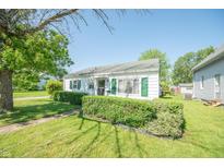 Charming home featuring a well-manicured front yard and classic architectural details at 1932 Central Ave, Columbus, IN 47201