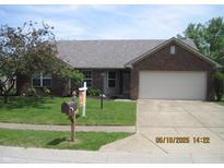 Charming single-story brick home with a two-car garage, green lawn and mature landscaping at 533 Charnwood Pkwy, Beech Grove, IN 46107