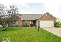 Charming one-story brick home with well-manicured lawn and an attached two-car garage at 533 Charnwood Pkwy, Beech Grove, IN 46107