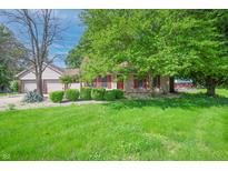 Charming single story home featuring a well manicured lawn, cozy curb appeal, and lovely red shutters at 6334 Teak Ct, Indianapolis, IN 46217