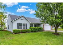 Charming single-story home boasts a manicured lawn and lush landscaping, enhancing its curb appeal at 7156 Chemistry Ct, Indianapolis, IN 46239