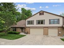 Inviting two-story home with a brick facade and a spacious two-car garage and concrete driveway at 774 Chapel Pines W Dr, Indianapolis, IN 46234