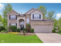 Charming two-story home with a well-manicured lawn, beautiful landscaping, and a two-car garage at 8745 Providence Dr, Fishers, IN 46038