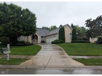 Charming home featuring a three-car garage and meticulously manicured landscaping at 9640 Bramblewood Way, Carmel, IN 46032