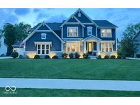 Charming two-story home with manicured lawn, professional landscaping, and classic architectural details at 1050 Windsor Estates Ct, Westfield, IN 46074