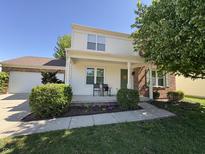 Charming two-story home with a welcoming front porch and a well-manicured lawn at 11163 Autumn Harvest Dr, Fishers, IN 46038