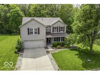 Aerial view of a two-story house with a two-car garage and well-manicured lawn at 1119 Albemarle Cir, Noblesville, IN 46062