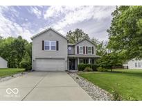 Traditional two-story home boasts a well-manicured lawn and an attached two-car garage at 1119 Albemarle Cir, Noblesville, IN 46062