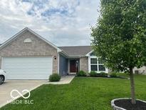 Charming home featuring brick and siding with a well-manicured lawn and attached two car garage at 1287 Northcraft Ct, Franklin, IN 46131