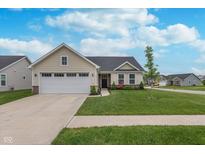 Charming one-story home featuring a pristine lawn, well-manicured landscaping, and a two-car garage at 17949 Scout Ln, Westfield, IN 46074