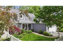 Charming gray home featuring a well-maintained lawn and delightful landscaping at 3602 Bay Rd S Dr, Indianapolis, IN 46240