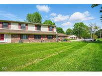 Inviting two-story townhouse with a well-maintained lawn and red shutters at 4505 Stratford Dr, Anderson, IN 46013