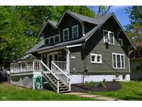 Charming home with a well-maintained lawn, inviting front porch, and lush, mature trees in a neighborhood setting at 455 E Main St, Danville, IN 46122