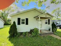 Charming single-story home with a cozy front porch, black shutters, and a well-manicured lawn at 4986 Adkins St, Columbus, IN 47201