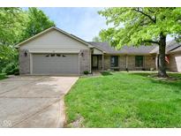 Charming single-story home with a well-maintained lawn and attached two-car garage at 5361 Carnoustie Cir, Avon, IN 46123