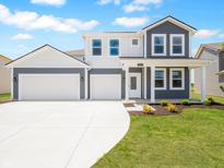 Charming two-story home with a two-car garage, well-manicured lawn, and welcoming front porch at 5540 Tart Blvd, Indianapolis, IN 46239