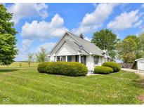 Charming home with white siding and a well-manicured lawn on a sunny day at 5855 S 25 W, Lebanon, IN 46052