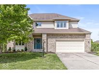 Charming two-story home with brick accents, attached garage, and well-manicured lawn at 6818 Bluffridge Dr, Indianapolis, IN 46278
